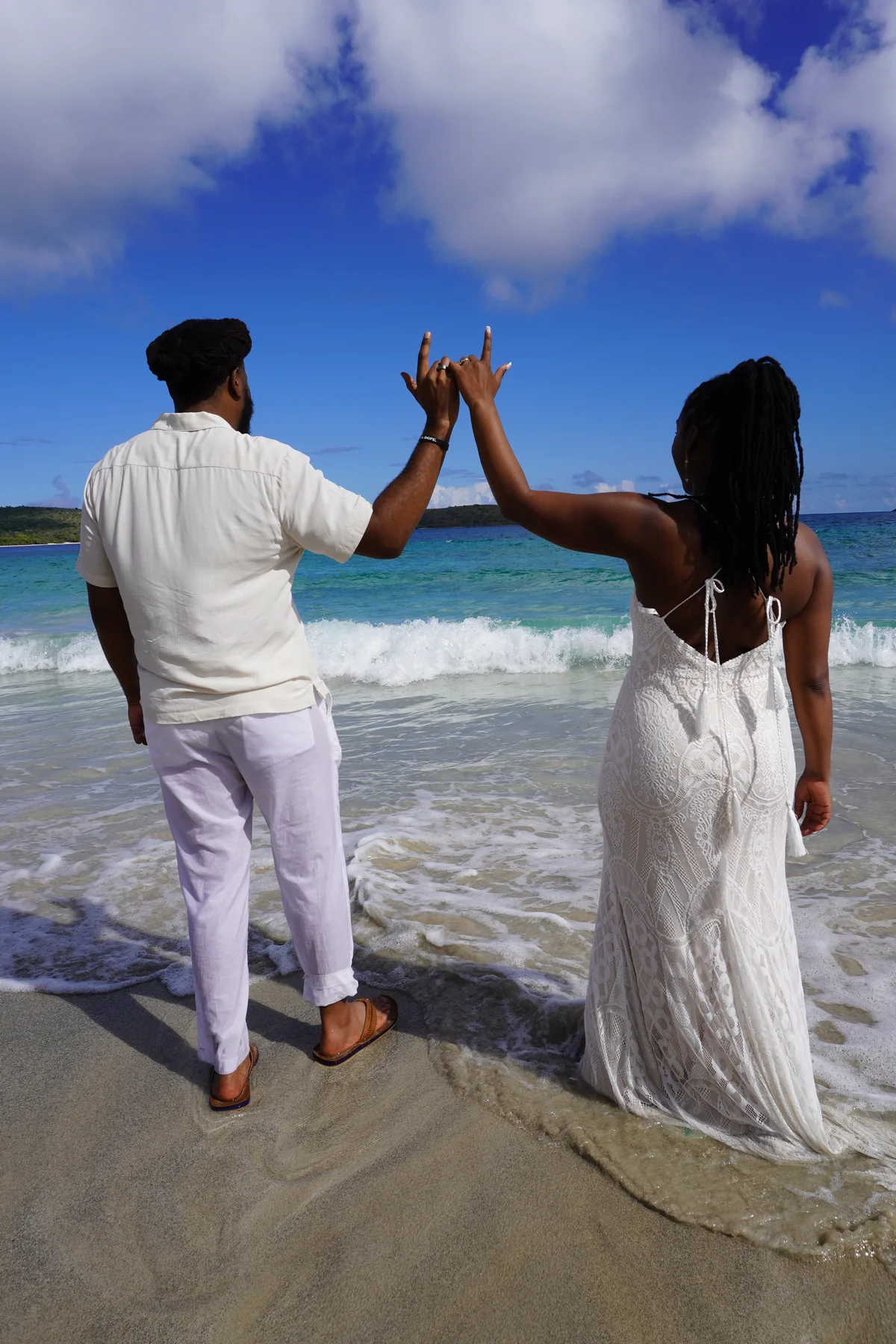 Bride and groom playful beach moment